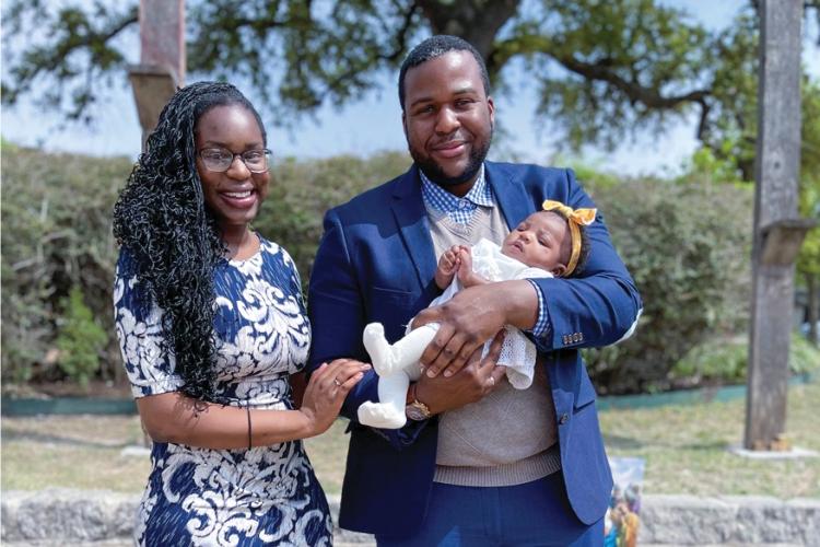 (Left to right) Chizitam Ibezim holding his infant daughter with his wife, Ginika Ibezim